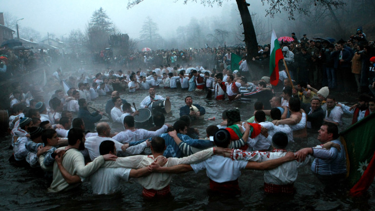 Epiphany Traditions – Jordan. Men dance in the icy waters